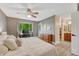 Comfortable bedroom featuring wood-look floors, a ceiling fan, access to a walk-in closet and en suite bathroom at 1572 W Long Ave, Littleton, CO 80120