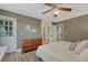 Relaxing bedroom featuring wood-look floors, a ceiling fan, and access to an exterior door at 1572 W Long Ave, Littleton, CO 80120