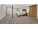Bright bedroom with stylish gray flooring, a comfortable bed, and ample closet space at 1572 W Long Ave, Littleton, CO 80120