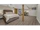 Spacious bedroom featuring modern flooring, a comfortable bed, and a functional workspace at 1572 W Long Ave, Littleton, CO 80120
