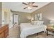 Inviting bedroom featuring wood-look floors, a ceiling fan, and a view of another bedroom at 1572 W Long Ave, Littleton, CO 80120