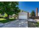Charming home featuring a well-manicured front lawn and a two-car garage at 1572 W Long Ave, Littleton, CO 80120
