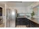 This is the kitchen with stainless steel appliances, granite countertops and white cabinets at 1572 W Long Ave, Littleton, CO 80120