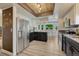 Modern kitchen with stainless steel appliances, breakfast nook and white cabinets at 1572 W Long Ave, Littleton, CO 80120