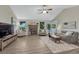Inviting living room with a brick fireplace and lots of natural light at 1572 W Long Ave, Littleton, CO 80120