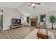 Spacious living room with a vaulted ceiling, fireplace, and light-filled windows at 1572 W Long Ave, Littleton, CO 80120