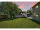 Lush backyard featuring a well-maintained lawn, mature tree, deck, and a two-story house at 18355 W 59Th Dr, Golden, CO 80403