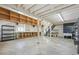 Unfinished basement with open rafters, large shelving, laundry hookups, and concrete floors at 18355 W 59Th Dr, Golden, CO 80403