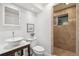 Charming bathroom showcasing a vessel sink, toilet, framed picture, and a tiled shower with a window at 18355 W 59Th Dr, Golden, CO 80403