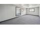 Bedroom with neutral colored walls, carpeted floor, mirror, and two windows at 18355 W 59Th Dr, Golden, CO 80403