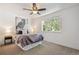 Serene bedroom with a comfortable queen-sized bed, an owl art piece, and natural light from the window at 18355 W 59Th Dr, Golden, CO 80403
