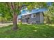 Home exterior view with a large tree in front of the home and a freshly cut lawn at 18355 W 59Th Dr, Golden, CO 80403