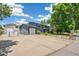 Side exterior of home featuring driveway, attached garage and solar panels at 18355 W 59Th Dr, Golden, CO 80403