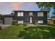 Charming two-story home with dark gray exterior and well-maintained front lawn at 18355 W 59Th Dr, Golden, CO 80403