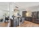 Bright, open-concept kitchen with stainless steel appliances, island, and views of living area at 18355 W 59Th Dr, Golden, CO 80403