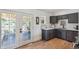 Charming kitchen featuring white cabinets, stainless steel appliances, and access to outdoor area at 18355 W 59Th Dr, Golden, CO 80403
