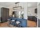 Stylish kitchen featuring modern appliances, island with a unique tile design, and wood-look flooring at 18355 W 59Th Dr, Golden, CO 80403