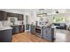 Modern kitchen featuring stainless steel appliances, a central island, and light-filled living space at 18355 W 59Th Dr, Golden, CO 80403