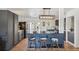 Kitchen island with blue tile detail, cowhide stools and modern appliances at 18355 W 59Th Dr, Golden, CO 80403