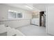 Basement laundry room with washer, dryer, storage shelf, and water heater at 18355 W 59Th Dr, Golden, CO 80403