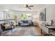 Bright living room with hardwood floors, modern furnishings, and lots of natural light at 18355 W 59Th Dr, Golden, CO 80403