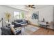 Bright living room with hardwood floors, modern furnishings, and lots of natural light at 18355 W 59Th Dr, Golden, CO 80403
