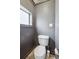 Small gray colored toilet room with concrete floors and a window at 18355 W 59Th Dr, Golden, CO 80403