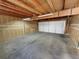 Spacious unfinished garage with exposed wood beams and ample storage at 3552 S Kittredge St # C, Aurora, CO 80013