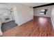 Living room with a beam, leading to a kitchen with white cabinets and appliances at 3552 S Kittredge St # C, Aurora, CO 80013