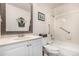 Bathroom featuring a vanity, toilet, and tiled shower-tub combination with grab bars for accessibility at 7750 W 87Th Dr # C, Arvada, CO 80005