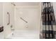 Tiled shower-tub combination with grab bars and a shower curtain at 7750 W 87Th Dr # C, Arvada, CO 80005