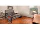Bedroom with wood floors is well lit and features a painting hanging on the wall at 7750 W 87Th Dr # C, Arvada, CO 80005