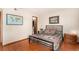 Bedroom features wood floors, neutral walls, and an open closet space at 7750 W 87Th Dr # C, Arvada, CO 80005