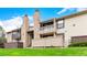 Exterior view of condos featuring neutral siding, private balconies, and lush green lawn at 7750 W 87Th Dr # C, Arvada, CO 80005