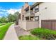 Condo exterior showcasing private balconies, manicured landscaping, and accessible walkways at 7750 W 87Th Dr # C, Arvada, CO 80005
