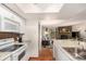 Open concept kitchen with granite countertops, white cabinetry and stainless steel sink at 7750 W 87Th Dr # C, Arvada, CO 80005