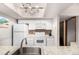 Bright kitchen featuring white cabinetry, granite countertops, stainless steel sink and white refrigerator at 7750 W 87Th Dr # C, Arvada, CO 80005