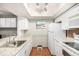 Bright kitchen featuring white cabinetry, granite countertops, stainless steel sink and white refrigerator at 7750 W 87Th Dr # C, Arvada, CO 80005