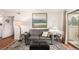 Living room featuring a painting, hardwood floors, neutral color palette and walkout balcony at 7750 W 87Th Dr # C, Arvada, CO 80005