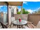 Outdoor patio featuring a round table with chairs and an exterior view of the residential complex at 7750 W 87Th Dr # C, Arvada, CO 80005
