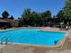 Community pool with clear blue water, lounging chairs, and plenty of space to relax at 7750 W 87Th Dr # C, Arvada, CO 80005