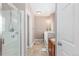 Bathroom featuring a tiled shower, vanity with sink, and neutral-toned walls and flooring at 12921 Grant W Cir # B, Thornton, CO 80241