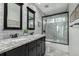 Bathroom with granite double vanity, shower, and updated tile at 9683 Las Colinas Dr, Lone Tree, CO 80124