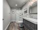 Bathroom featuring a glass shower, wood-style flooring, and gray vanity at 9683 Las Colinas Dr, Lone Tree, CO 80124