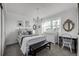 Bright bedroom with a window, decorative shelves, a mirror, and a black bench at 9683 Las Colinas Dr, Lone Tree, CO 80124