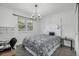 Bedroom with a white four poster bed, small desk, and decorative light fixture at 9683 Las Colinas Dr, Lone Tree, CO 80124