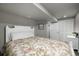 Basement bedroom with white bed frame, floral bedding, and closet doors at 9683 Las Colinas Dr, Lone Tree, CO 80124