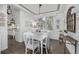 Dining room with white furnishings, chandelier, and wainscoting, complemented by hardwood floors at 9683 Las Colinas Dr, Lone Tree, CO 80124