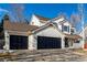 Charming two-story home with a three-car garage, well-manicured lawn, and inviting front porch at 9683 Las Colinas Dr, Lone Tree, CO 80124