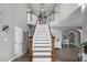 Grand foyer with a staircase leading to the upper level and a gallery wall of photos at 9683 Las Colinas Dr, Lone Tree, CO 80124